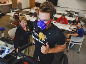 Faculty member and student measuring oxygen on a treadmill run