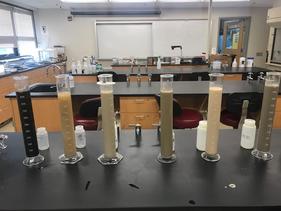Beakers in a classroom lab with different soil types