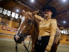 Western rider posing with her horse in the Charles H. Casey Arena